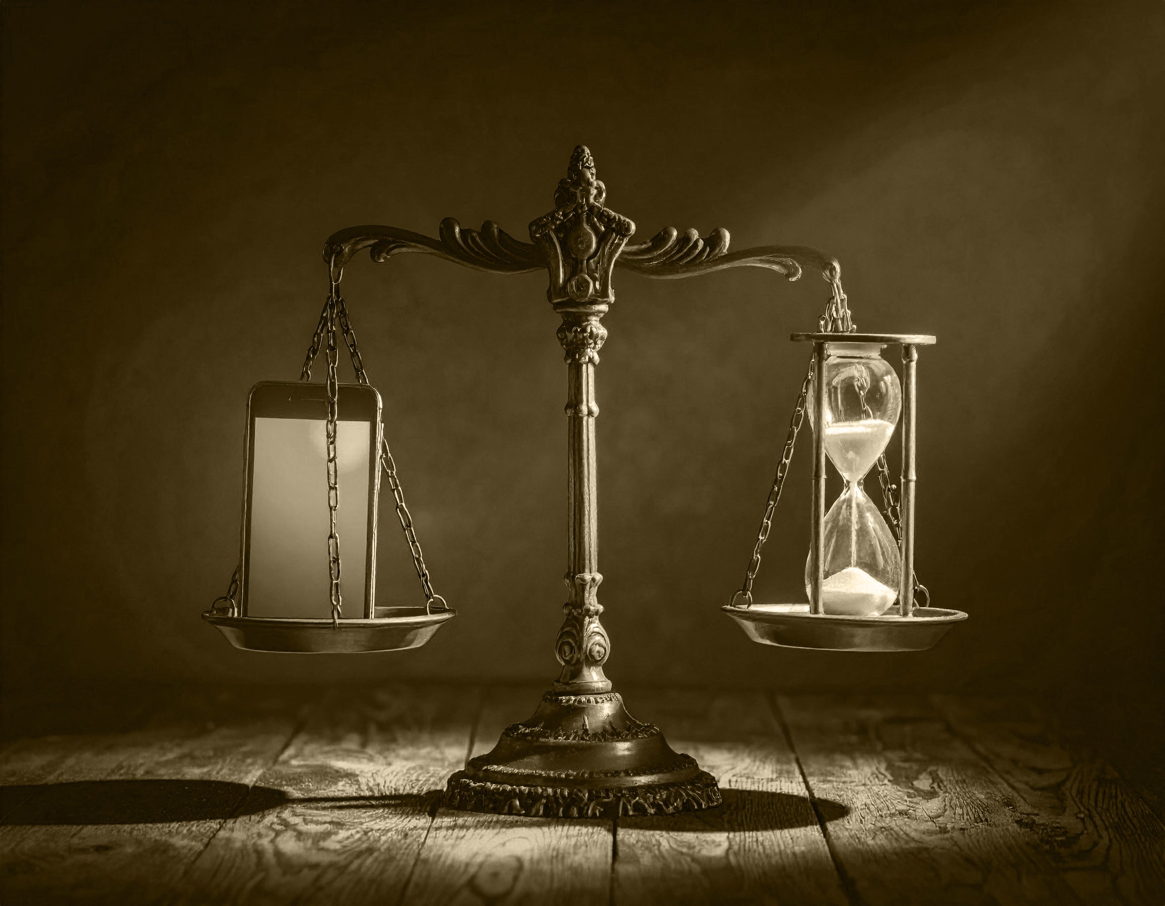 antique scale with phone and hourglass